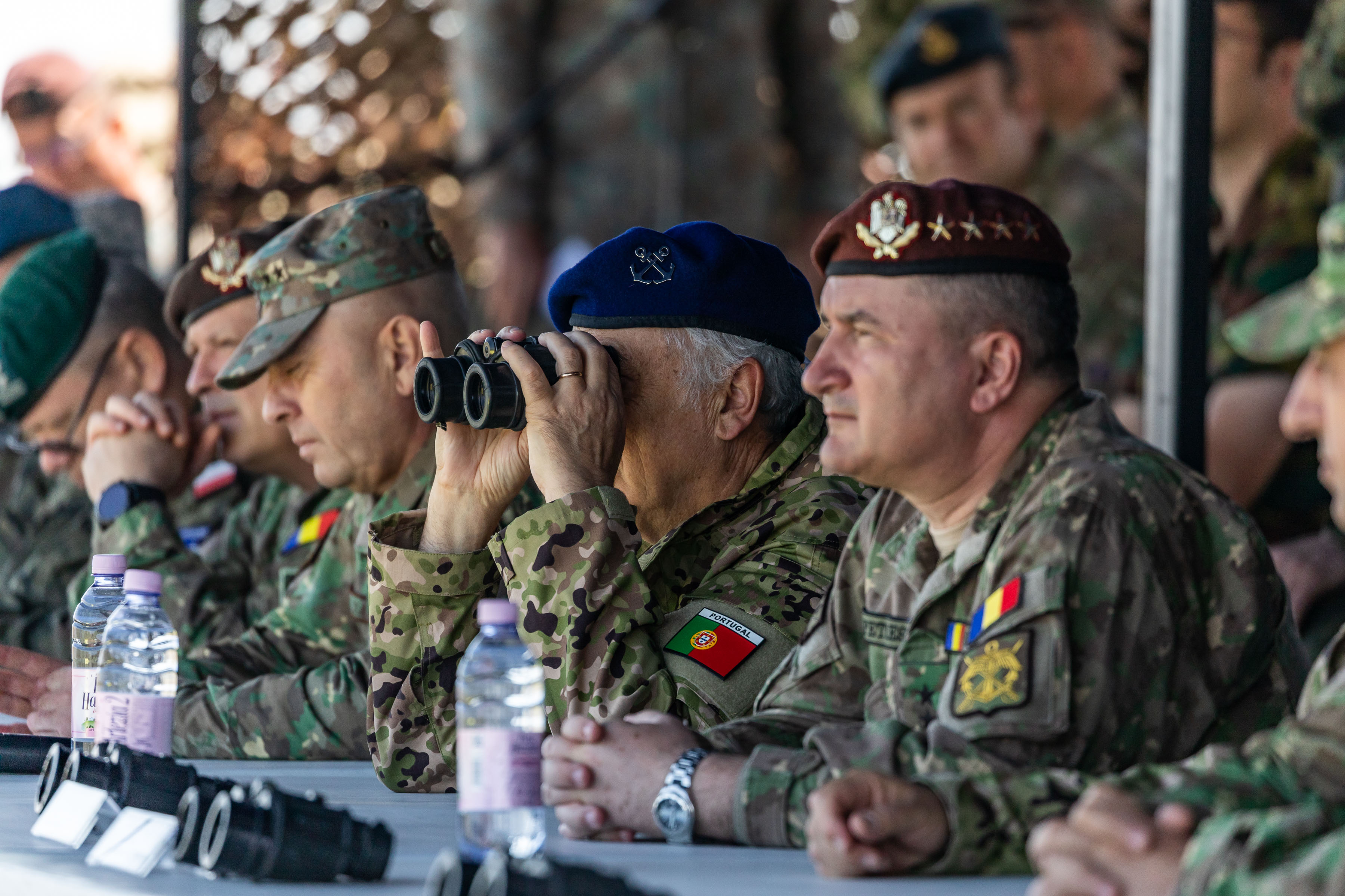 Romanian personnel sitting with binoculars.